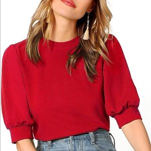 Red top with puffed sleeves.